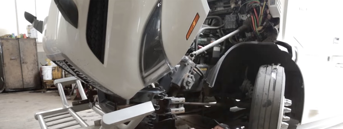 Mechanic working on truck wheel assembly